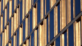 Golden window frames on a high office building, with blue sky reflection in glass panes, on a bright sunny day - abstract pattern in luxurious modern architecture, headquarters of wealthy corporation. - Powered by Shutterstock - Get 15% off with code: PIKWIZARD15
