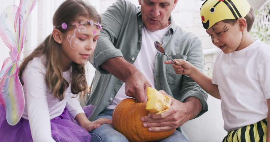 Halloween, carving pumpkin and grandfather with children enjoying festival tradition, decoration and fun activity. Family, love and grandpa bonding with kids on holiday, vacation and celebration | Shutterstock HD Video #1097324705