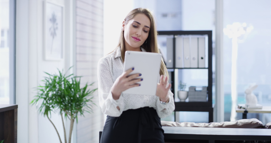Tablet, research and design with a business woman working alone in her office as a creative designer. Internet, app and innovation with a a female employee at work on creativity for a project | Shutterstock HD Video #1097324897