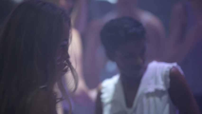 Party, disco and women dance at night in energetic crowd at nightclub, concert or festival. Celebrate, event and happy energy of friends dancing to music together and enjoying night club.