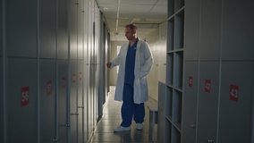 A male doctor came to the locker room after a difficult day at the hospital - Powered by Shutterstock - Get 15% off with code: PIKWIZARD15