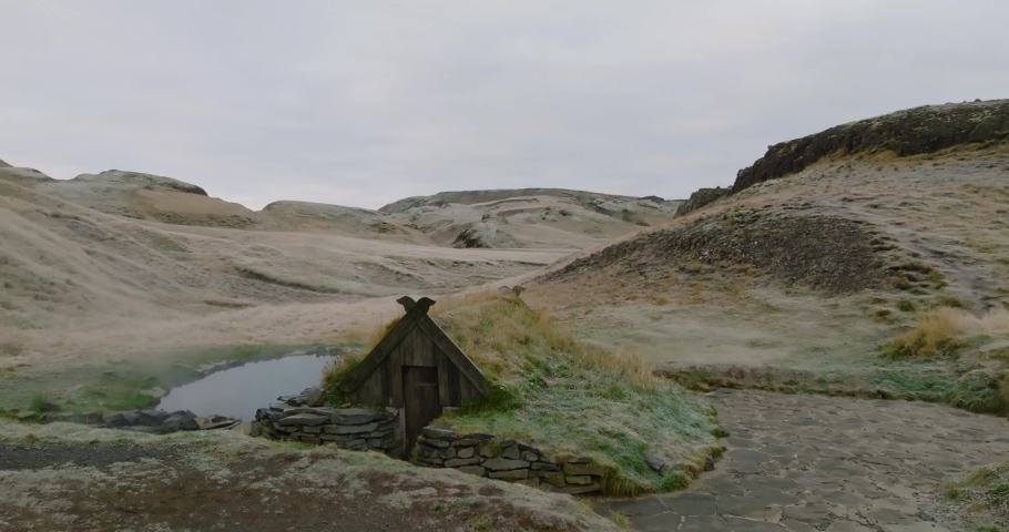 aerial view of hot baths at Hrunalaug Hot Spring with small wooden hut