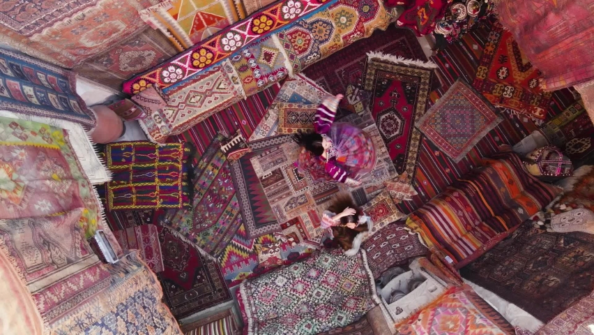 Two girls in dress dancing on national carpets of Turkey in Cappadocia, Aerial view, Drone footage Royalty-Free Stock Footage #1097331295