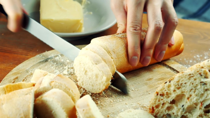 Slicing French Baguette On Slice For Bruschetta Or Canape. Cutting Bread On Kitchen. Making Morning Breakfast. Fresh Bread Canape. Cutting French Baguette. Sliced Baguette For Antipasto Bruschetta | Shutterstock HD Video #1097332021