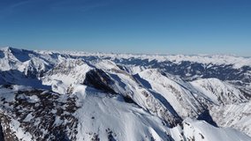 Cinematic footage taken in the Austrian mountains. 4K drone video of snow covered ski mountains.