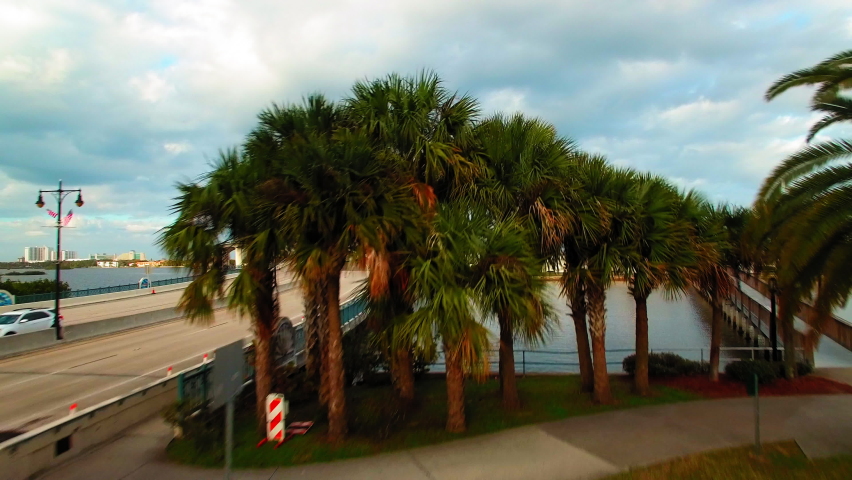 Aerial Forward Shot Of Volusia County Library Center By Bridge Over Sea Under Cloudy Sky - Daytona Beach, Florida