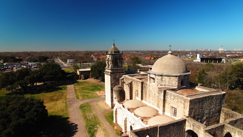 Aerial Shot Of Cross Symbols On Historic Church By Houses In City, Drone Flying Forward During Sunny Day - San Antonio, Texas
