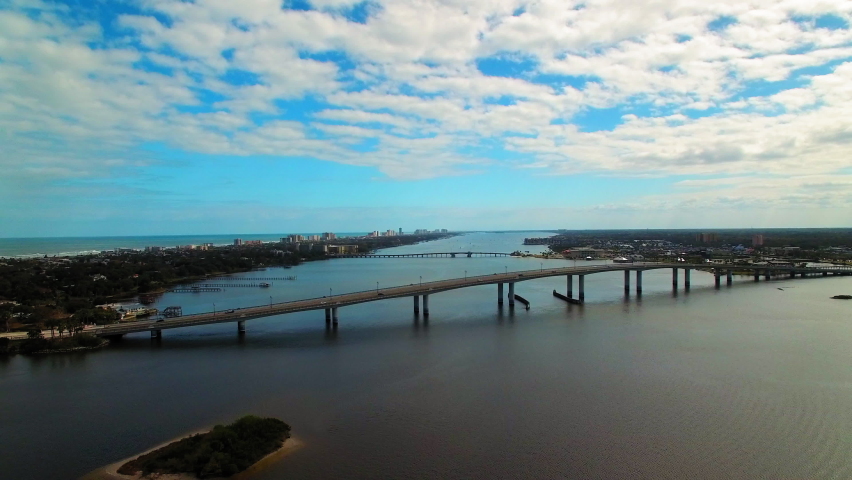 Aerial Panning Beautiful View Of Bridges Over Rippled Sea Under Cloudy Sky - Daytona Beach, Florida