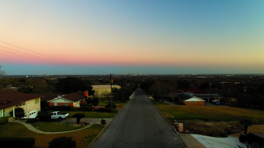 Aerial Forward Ascending Shot Of Residential Houses Amidst Trees In City Against Sky At Sunset - San Antonio, Texas Royalty-Free Stock Footage #1097336181