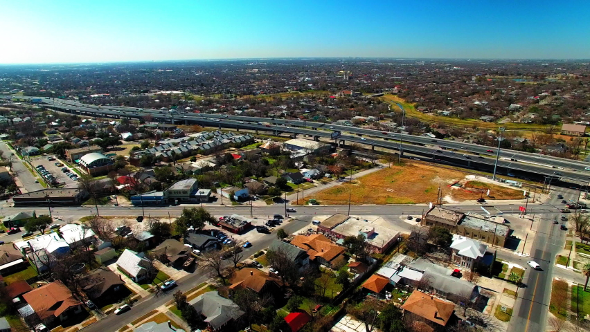 Aerial Shot Of Cars Moving On Bridges In City, Drone Flying Forward Over Houses During Sunny Day - San Antonio, Texas
