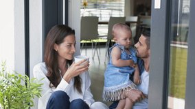Young family with baby girl enjoying morning coffee at home on a balcony. - Powered by Shutterstock - Get 15% off with code: PIKWIZARD15