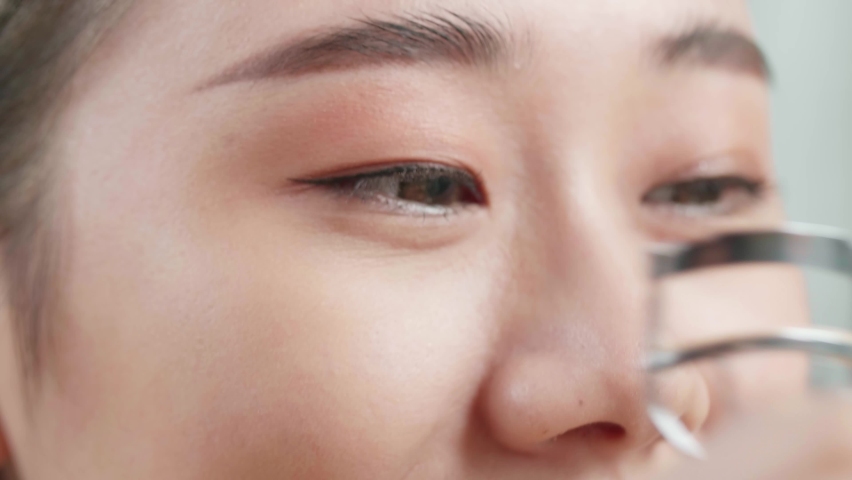 Close Up Of Beautiful Young Asian Woman Using An Eyelashes Curler While Applying Makeup At Home
 Royalty-Free Stock Footage #1097343263