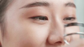 Close Up Of Beautiful Young Asian Woman Using An Eyelashes Curler While Applying Makeup At Home
 - Powered by Shutterstock - Get 15% off with code: PIKWIZARD15