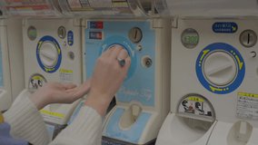 This close up video shows a hands using toy vending machines in Japan. - Powered by Shutterstock - Get 15% off with code: PIKWIZARD15