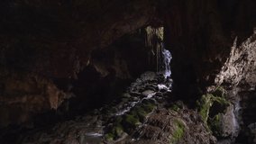 Waterfall in rocky dark cave. Beauty of nature, rare places under the Earth surface. Magnificent wildlife landmarks - Powered by Shutterstock - Get 15% off with code: PIKWIZARD15