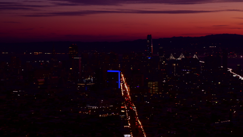 Time lapse of San Francisco below purple skyline at night. Bay, ocean coast and skyscrapers with magnificent, colorful sunset in the background. High quality 4k footage