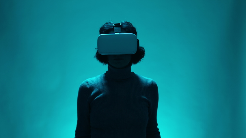 Mature female model with VR headset user in digital interactive performance, entertainment of future technology. Woman in virtual or augmented reality glasses touching invisible objects in slow motion Royalty-Free Stock Footage #1097355179