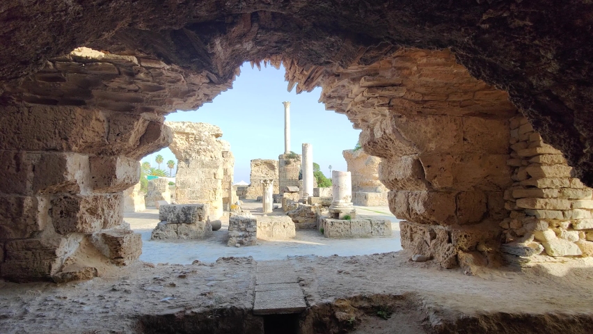 View of the historical landmark The Baths of Antoninus in Carthage , Tunisia. Unesco World Heritage Site. Archaeological Site of Carthage. Place of historic interest. Ancient ruins.  Royalty-Free Stock Footage #1097358061