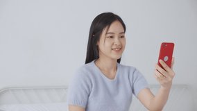 Young asian woman using smartphone for video conference online with friends, businesswoman working with video call for meeting with social network with smart phone, business and communication concept.