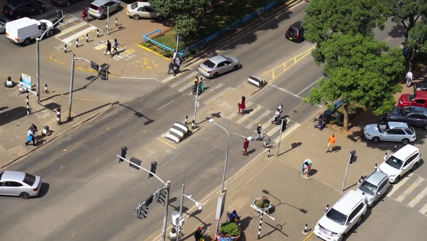 Birds eye view of pedestrians crossing the road during traffic in Kenya, Nairobi.
