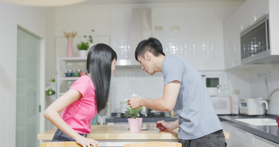 asian couple are chatting and using mobile flashlight to illuminate are looking for something after power outage in kitchen at home Royalty-Free Stock Footage #1097364023