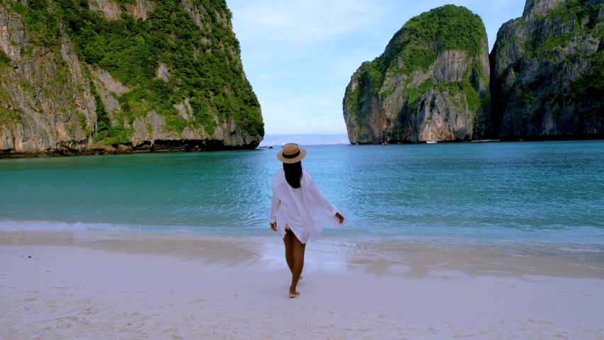 Thai women with a hat walking on the beach at Koh Phi Phi Thailand at Maya Bay the famous beach in Thailand | Shutterstock HD Video #1097364607