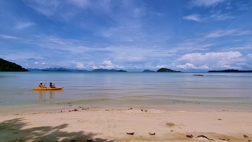 Men and women in a kayak at a tropical beach in Thailand, Koh Mak Island. 