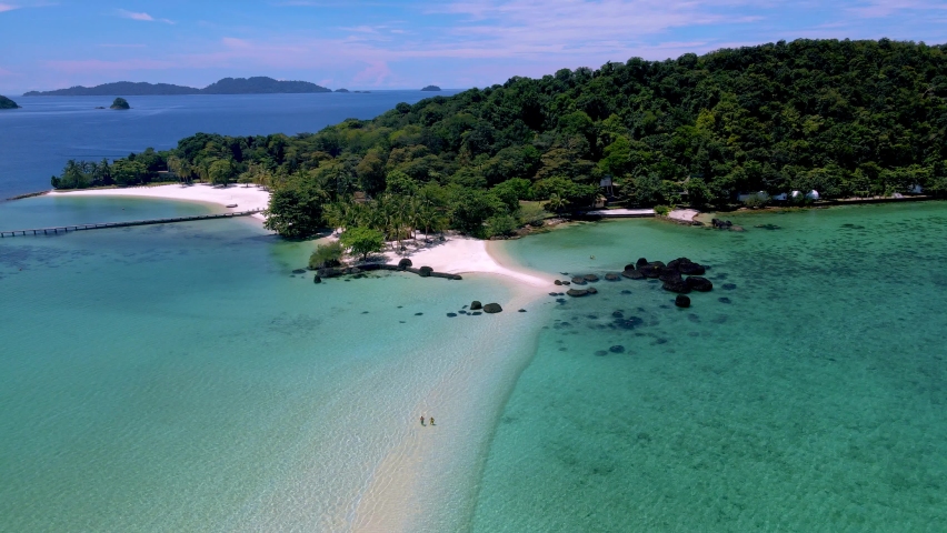 Drone aerial view at a Couple man and women on a tropical island in Thailand, Koh Kham Island Trat Koh Mak. tropical beach with white sand and blue ocean with palm trees | Shutterstock HD Video #1097364625