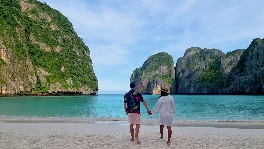 A couple of men and women walking on the beach at Koh Phi Phi Thailand at Maya Bay in the morning | Shutterstock HD Video #1097364629