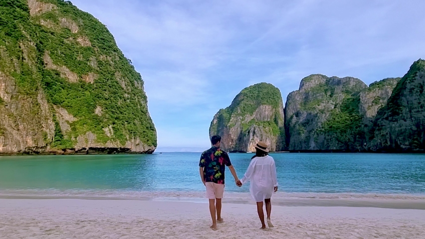 Empty Maya beach Koh Phi Phi, A couple of men and women walking on the beach at Koh Phi Phi Thailand at Maya Bay in the early morning | Shutterstock HD Video #1097364639