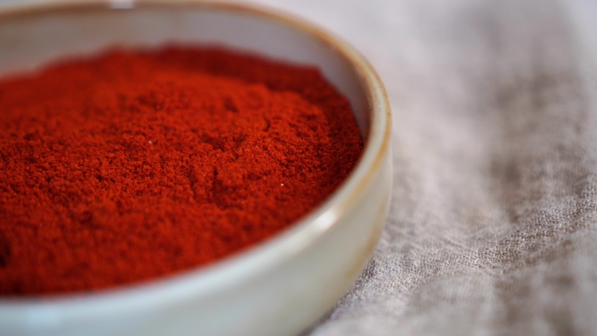 Red pepper powder moving shot on a plate