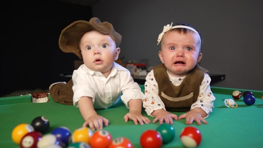 two kids in retro clothes on a billiard pool table. happy family kid dream concept lifestyle. twin brother and sister billiards gangsters