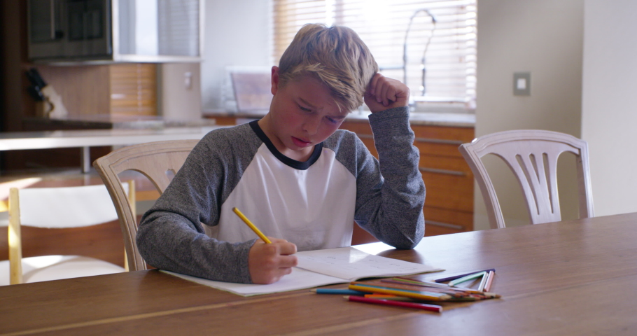 Angry, confused and frustrated child with learning problem, dyslexia or adhd with homework at table feeling stress, depression and anxiety. Autism boy throw book and pencil while stressed from school Royalty-Free Stock Footage #1097378307