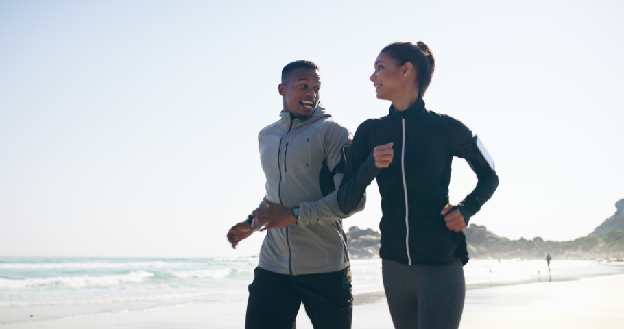 Couple, fitness and running on the beach having fun and being silly and joking for athletic sporty activity. Fit, african american man and woman run by the ocean with freedom for exercise and workout Royalty-Free Stock Footage #1097378431