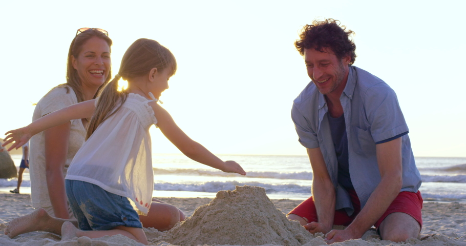 Family, beach and sand, castle and relax in summer, fun and learning, playing and bond at sunset. Happy family, building and sand castle by girl and parents in Miami for travel, vacation and holiday