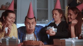 birthday dream. father man blows out the candles on the cake in a circle of happy family. birthday celebration kid dream concept. father friendly happy family team celebrating birthday lot of people - Powered by Shutterstock - Get 15% off with code: PIKWIZARD15