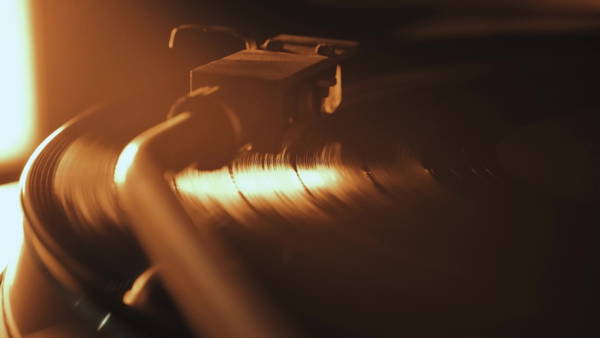 A vinyl record spins in the gramophone music player and plays an old disco. Close-up shot of retro vinyl record player Royalty-Free Stock Footage #1097384179