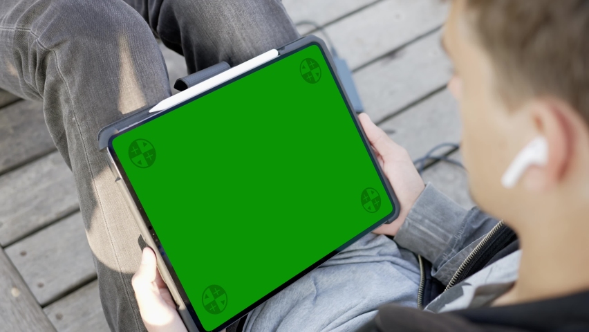 Male Working Outdoor with Tablet Computer