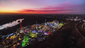 Establishing Aerial View Shot of London UK, United Kingdom, fun fair in Hyde Park, ferris wheel, roller coaster, Winter Wonderland