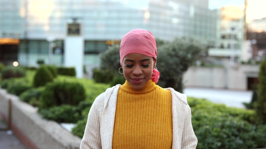 video portrait of young woman with cancer, breast cancer survivor, african american with a pink handkerchief symbol of the fight against cancer Royalty-Free Stock Footage #1097397835