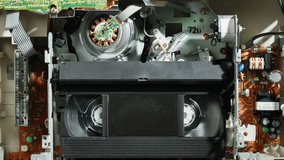 Old video recorder inside close-up, VHS. Retro player, vintage video cassette broadcasting, audio tape. 