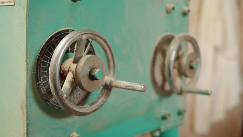 Craft beer production factory, brewery manufacture. Putting barley malt grains in conveyor close-up. Brewing, cooking alcohol in metal vats bottles.