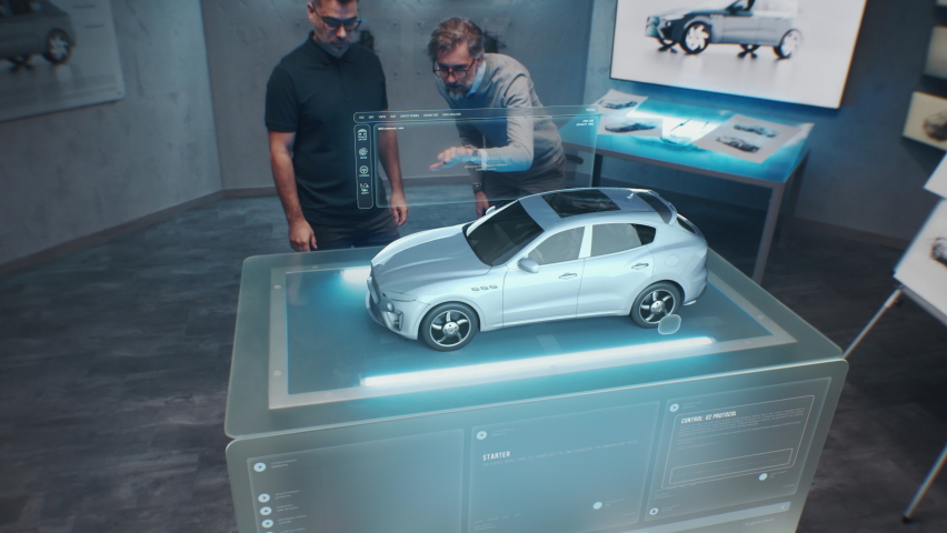 Two engineers Developers standing in design studio near futuristic holographic table and make a test in a 3d car crash test simulator, which simulates a road accident check the safety Royalty-Free Stock Footage #1097401769