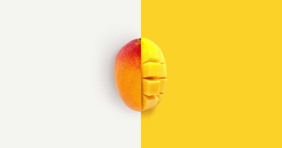 Creative animation made of mango full an peeled on the white and yellow background. Animation concept food. 
