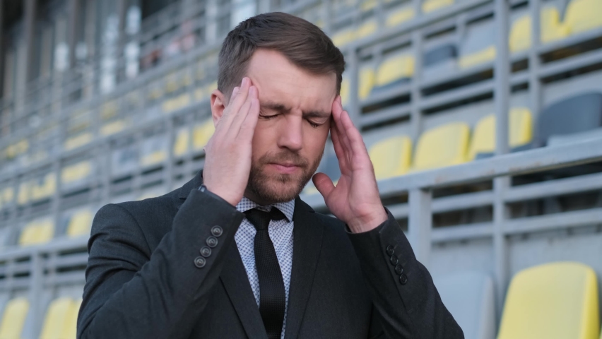 Young handsome businessman suffering from headache. Migraine | Shutterstock HD Video #1097404391