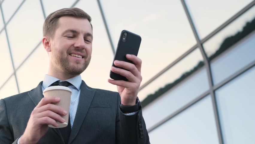 Portrait of successful bearded businessman, director, coach trainer drinking coffee and looking at smartphone. | Shutterstock HD Video #1097404399