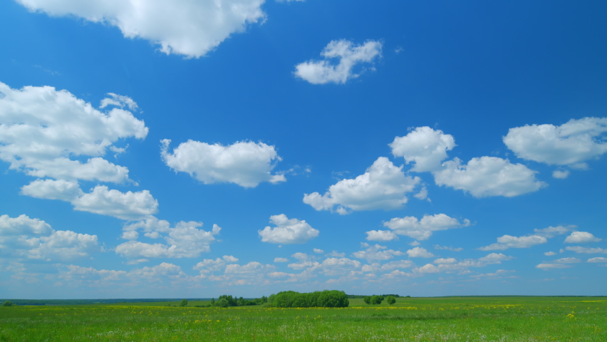White clouds passing by sky at daytime. Clear weather and cumulus clouds transforming in like dreamy landscape in spring or summer season. Wide shot. Timelapse. Royalty-Free Stock Footage #1097404731