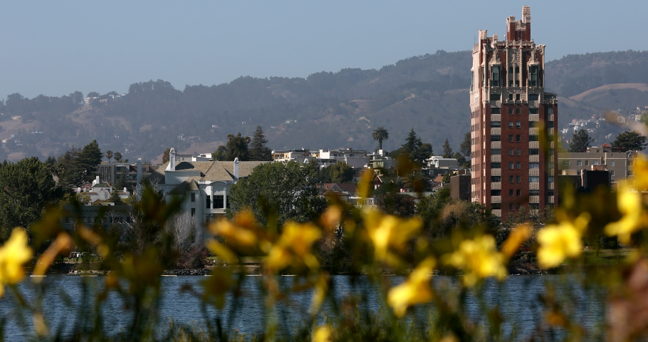 Afternoon view of the lake shore skyline of Lake Merritt in Oakland, California, USA.