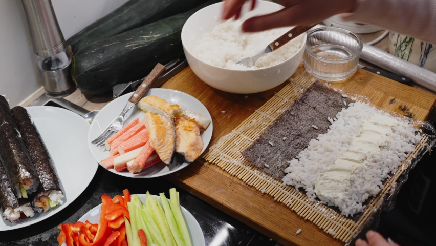 Person Adding Crab On Sushi Roll, Preparing For Dinner At Home  | Shutterstock HD Video #1097410637