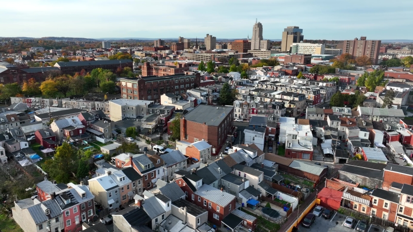 Urban American city. Downtown housing district. Rowhomes, homes and colorful historic houses with skyscraper in distance. Royalty-Free Stock Footage #1097411469